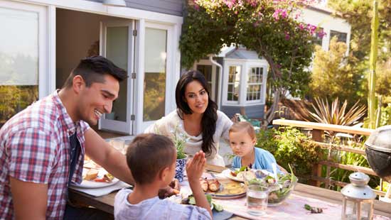 Family eating together in their back yard